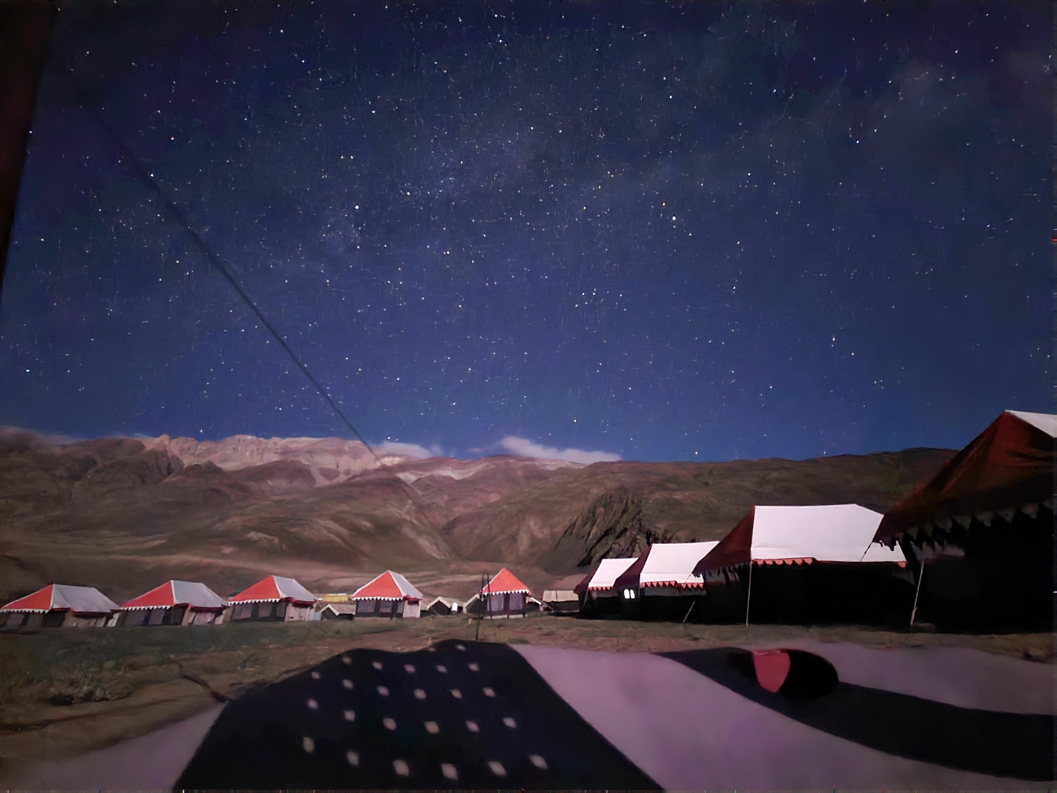 View from a monastery overlooking a wide valley with a river and green fields