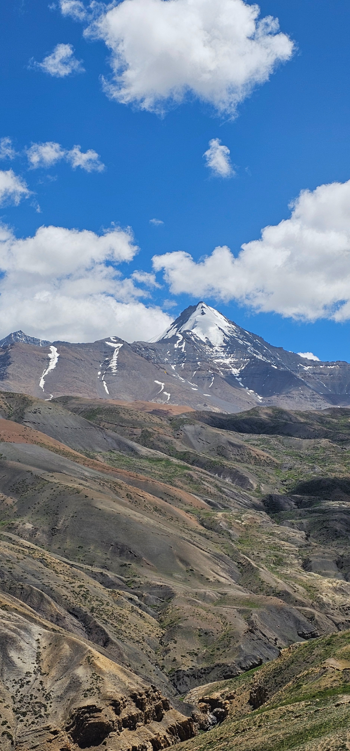 A prominent snow-capped mountain peak against a clear blue sky