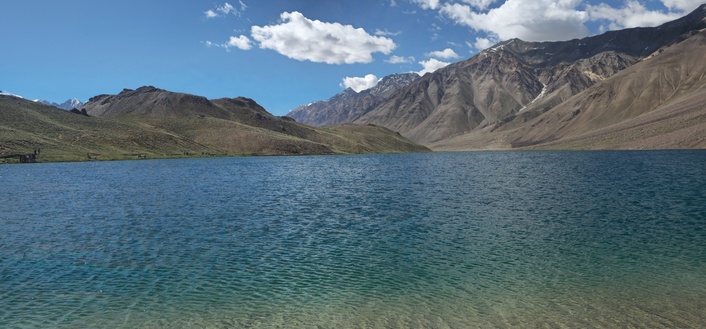 The serene blue waters of Chandratal Lake nestled amidst mountains